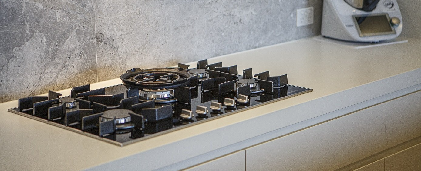 A stove top oven is sitting on top of a counter in a kitchen.